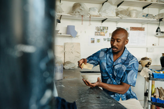 A man wearing SIRPLUS navy floral cuban shirt made from liberty fabrics